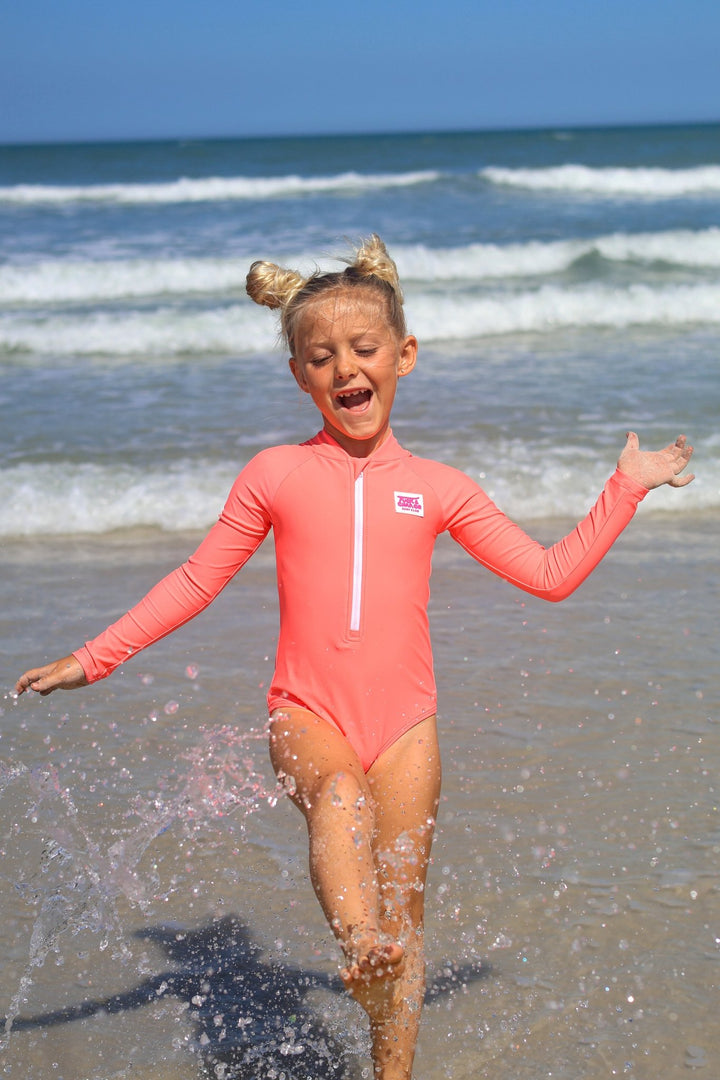 UPF 50+ Neon Coral Girls One Piece Long Sleeve Swimsuit - Tuck &amp; Char Co.