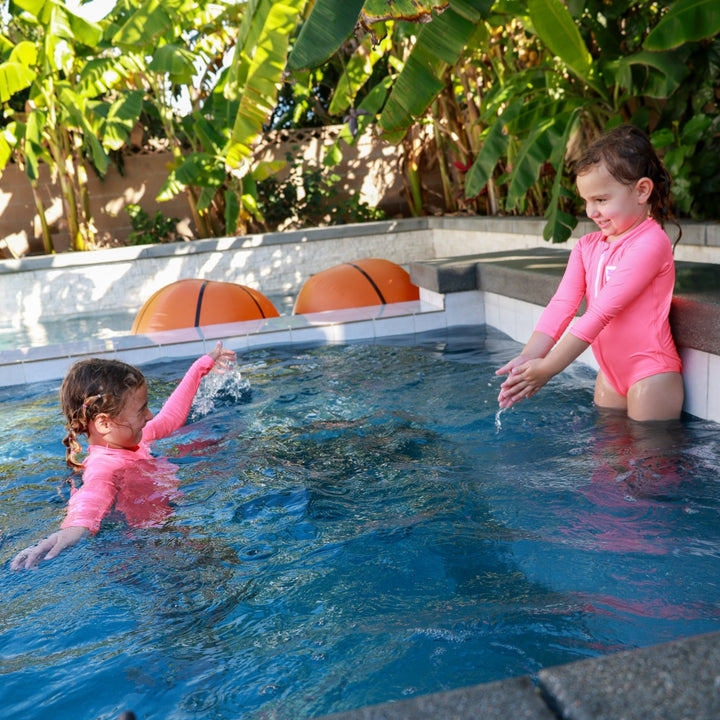 UPF 50+ Neon Coral Girls One Piece Long Sleeve Swimsuit - Tuck &amp; Char Co.