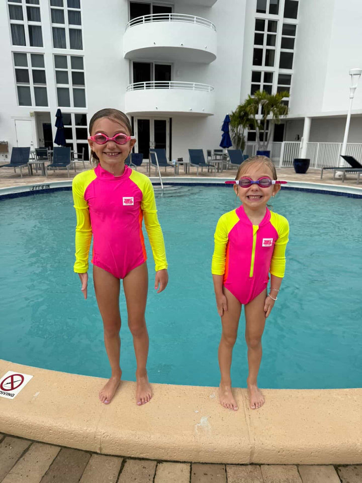 UPF 50+ Neon Pink Color Block Girls One Piece Long Sleeve Swimsuit - Tuck &amp; Char Co.